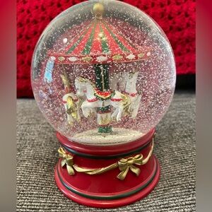 Festive Carousel Snow Globe with Red and Gold Accents